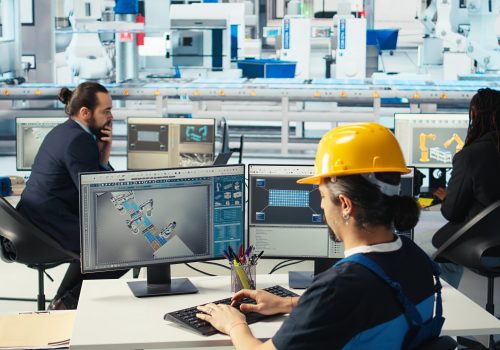 Photovoltaics factory engineer using CAD software, planning work on facility floor. Solar panels manufacturing plant technician designing assembly lines on computer, camera A